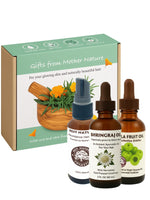 Three bottles of natural oils Amla, Bhrignraj, Hair Abundance with a 'Gifts from Mother Nature' box on a white background