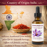 Bottle of Kumkumadi oil with a map of India and saffron on a wooden surface.