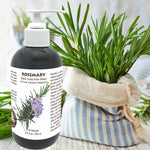 Black soap aloe wash bottle with rosemary label next to a plant and striped cloth on a light background